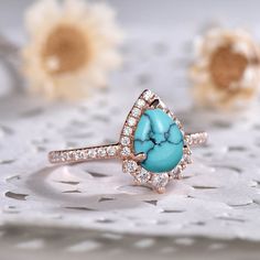 This is an turquoise engagement ring rose gold. The stones are turquoise and VVS man made cz diamond. The center turquoise is about 6x8mm Pear shape Cut. The stones can be replace with other gemstones.For example,if you don't like the CZ accent,you can ask me replace it with tourmaline,aquamarine,diamond,emerald,sapphire... For custom making jewelry,it can be made in 2 different metal. 1,Solid gold,including 14/18k white/rose/yellow gold. 2,925 sterling silver with white/yellow/rose gold plated. Elegant Turquoise Teardrop Ring For Anniversary, Turquoise Engagement Ring, Turquoise Ring Engagement, Turquoise Statement Ring, December Birthstone Ring, Antique Wedding Rings, Moonstone Engagement, Moonstone Engagement Ring, Turquoise Boho