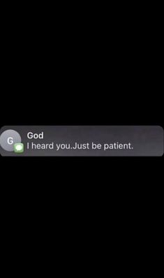 the text on the phone says, god i heard you just be patient and it is dark