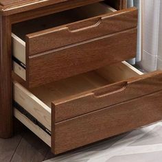 a wooden dresser with two drawers in it