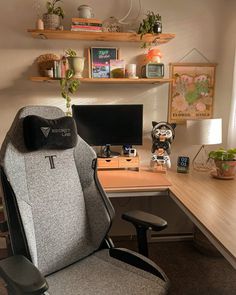 an office chair with a bow tie on the back sits in front of a computer desk