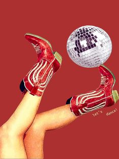 a woman's legs and red boots are shown with a disco ball in the air