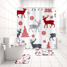 a bathroom decorated for christmas with deer and snowflakes on the shower curtain, toilet seat covers and rugs