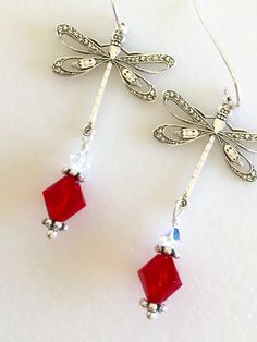 "Beautiful antique silver filigree dragonfly earrings featuring lovely large 8mm Siam red Swarovski Crystal and 4mm clear Swarovski Crystal AB. Silver dragonfly charms are 24 x 24mm and hang from Sterling silver ear wires. Total length is 2\". Lightweight and beautiful red crystal earrings! Available on Sterling silver ear wires or silver plated wires." Elegant Dragonfly Earrings With Ear Wire, Elegant Dragonfly Jewelry With Ear Wire, Elegant Hypoallergenic Dragonfly Earrings, Elegant Dragonfly Jewelry For Jewelry Making, Paris Charm Bracelet, Dragonfly Charm, Dragonfly Earrings, Earrings Red, Swarovski Crystal Earrings