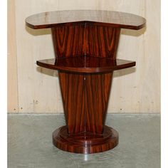 a round wooden table with two shelves on each side