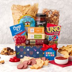 an assortment of snacks, crackers and condiments on a table