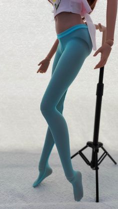 a doll is posed next to a microphone