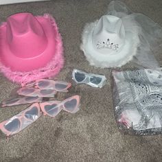 several hats and sunglasses are laying on the floor