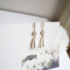 Super dainty Teardrop Pearl earrings.Great jewelry for any occasion.▶ Material - Pearl, Gold or Rhodium plated over brass, Clear stone▶ Earring Length - 48mm (app. 1.9 inches)▶ Measure - Pearl H. 22mm x W. 10mm, Stone 6mm▶ The jewelry comes in a gift box** Please check the shop policy for shipping information and jewelry carehttps://www.etsy.com/shop/Brillants/policy?ref=shopinfo_policies_leftnav Dainty Teardrop Bridal Earrings For Gift, Dainty Teardrop Bridal Earrings, White Teardrop Earrings With Elegant Design For Gifts, Hypoallergenic Pear-shaped Teardrop Earrings For Wedding, Dainty Teardrop Crystal Earrings For Wedding, Dainty Teardrop Dangle Earrings For Weddings, Dainty Drop Bridal Earrings For Wedding, Dainty Drop Bridal Earrings, Dainty Teardrop Bridal Earrings For Wedding