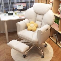 a white leather recliner chair with a yellow flower pillow on the arm rest in front of a computer desk