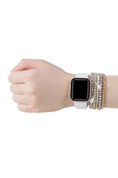 a woman's arm with an apple watch on it and bracelets around her wrist