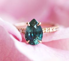 a close up view of a ring with a large blue stone on the front and side