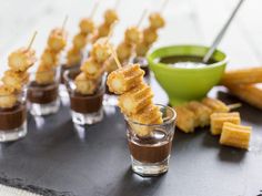 small cups filled with dipping sauce and appetizers