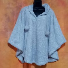 This Is A Hooded Poncho Or Cape. It Is A Fluffy Light Gray Material. The Hood Is A Cute Sleeping Owl Face With Ears. There Are Balls Hanging From Each Side Of The Strings. This Is A Plus Size One Size Fits All, But I Believe It Would Also Fit Smaller Sizes As Well. This Is New With Tags. Casual One Size Cape For Cold Weather, Casual One-size Cape For Cold Weather, Cozy Solid Poncho For Winter, Cozy Poncho For Winter, Casual One-size Cape For Winter, Casual Hooded Winter Cape, Hooded Winter Poncho One Size, Winter Hooded Poncho One Size, Casual Hooded Poncho For Cold Weather