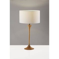 a table lamp with a white shade on it's base and a light bulb in the middle