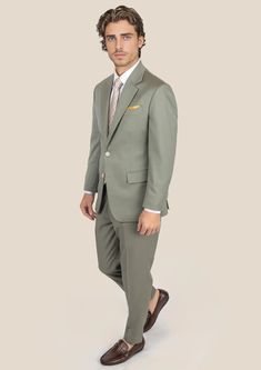 Elevate your style game with the Verona Sage Twill Suit. Crafted from luxurious merino wool by Vitale Barberis Canonico, Italy, this custom-made suit exudes elegance and makes a bold statement wherever you go. Its sleek design and eye-catching color will surely turn heads and inspire you to take on new challenges with confidence. Semi-formal Custom Fit Set With Notch Lapel, Custom Fit Suit In Suiting Fabric, Custom Fit Notch Lapel Set For Semi-formal Occasion, Luxury Fitted Sets For Workwear, Custom Fit Notch Lapel Sets For Business Casual, Luxury Single Breasted Workwear Set, Elegant Green Business Casual Suits, Classic Long Sleeve Custom Fit Sets, Elegant Long Sleeve Sets With Welt Pockets