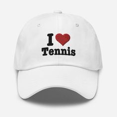 The Tennis Hat, featuring "I Love Tennis," is a perfect dad hat and tennis cap. This baseball cap serves as an ideal tennis gift idea, making it a thoughtful gift for tennis players, whether for mom or any tennis enthusiast. Dad hats aren't just for dads. This one's got a low profile with an adjustable strap and curved visor. * 100% chino cotton twill * Green Camo color is 35% chino cotton twill, 65% polyester * Unstructured, 6-panel, low-profile * 6 embroidered eyelets * 3 ⅛" (7.6 cm) crown * Adjustable strap with antique buckle * Blank product sourced from Vietnam or Bangladesh This product is made especially for you as soon as you place an order, which is why it takes us a bit longer to deliver it to you. Making products on demand instead of in bulk helps reduce overproduction, so thank White Baseball Cap For Tennis, White Tennis Baseball Cap, White Adjustable Hat For Tennis, White Tennis Cap, Adjustable White Hat For Tennis, White Adjustable Tennis Hat, Adjustable White Tennis Hat, Adjustable Tennis Cap, Adjustable Curved Brim Tennis Hats