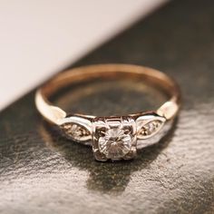 a diamond ring sitting on top of a table