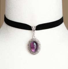 Step into the opulent world of Victorian elegance with our exquisite Black Velvet Choker featuring an enchanting Amethyst Gemstone Pendant. Crafted from luxurious black velvet ribbon and a stunning amethyst gemstone set in a delicate antique silver filigree setting, this choker is the perfect blend of vintage charm and modern elegance. Key Features: Genuine Amethyst Gemstone: The centerpiece of this choker is a radiant amethyst gemstone, beautifully set in an antique silver filigree housing. The Victorian Gothic Jewelry, Black Velvet Ribbon, Black Velvet Choker, Velvet Choker, Victorian Jewelry, Choker Necklaces, Velvet Ribbon, Silver Filigree, Stylish Gifts