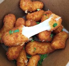 some fried food in a brown box on a table