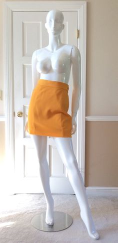 This vintage Moschino skirt is in his iconic taxi cab/school bus yellow. Fully lined in yellow rayon. Side zipper with self button. Front and back shaping seams. Measurements - Waist - 27’Hips - 36”Length - 18” Chic Fitted Yellow Pencil Skirt, Chic Yellow Fitted Pencil Skirt, Chic Fitted Yellow Skirt, Retro High-waist Fitted Mini Skirt, Retro Fitted High Waist Mini Skirt, Retro Fitted High-waist Mini Skirt, Fitted High Waist Retro Mini Skirt, Yellow Workwear Bottoms Shorts, Yellow Short Bottoms For Work