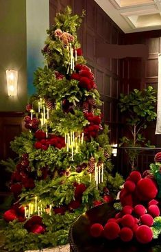 a christmas tree decorated with red balls and greenery