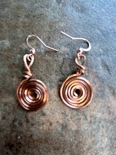 Handmade copper wire earrings. Lightweight and contemporary flower design. Adjustable Copper Wire Pierced Earrings, Handmade Spiral Copper Wire Earrings, Spiral Copper Wire Earrings As Gift, Unique Bronze Copper Wire Earrings, Rose Gold Wire Wrapped Copper Wire Earrings, Rose Gold Wire Wrapped Earrings In Copper, Rose Gold Wire Wrapped Earrings, Rose Gold Spiral Nickel-free Earrings, Rose Gold Spiral Earrings With Ear Wire