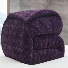 two purple towels stacked on top of each other