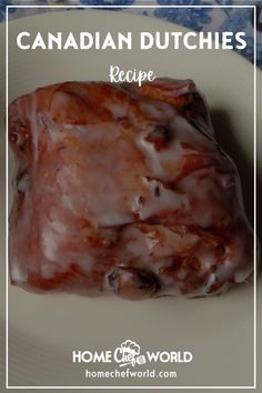 a white plate topped with meat covered in glaze and icing on top of a blue floral table cloth