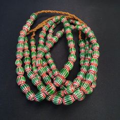 Vintage Venetian African Style Green Glass Chevron 9mmx13mm Beads Long Strand  Chevron Beads SIX Layer Type of Object Drawn, multi-layered glass Color BLUE, RED, White  Approximate Age Late 20th century Overall  * Condition: Good to fair.  * See picture with Size measurement tool for size comparison.  * Strand Length 26 inches (includes string/raffia) * Brand: Unbranded  * Style: Beaded  * Type: Strand of beads This strand is not intended to be a ready-to-wear necklace. Although the Traditional Green Beaded Necklace With Large Beads, Traditional Green Beaded Necklaces With Wooden Beads, Traditional Green Beaded Necklace With Wooden Beads, Traditional Green Beads As A Gift, Traditional Green Necklaces With Oval Beads, Traditional Green Necklace With Oval Beads, Vintage Green Wooden Beads, Green Beaded Necklace With Large Oval Beads, Unique Faceted Oval Beads