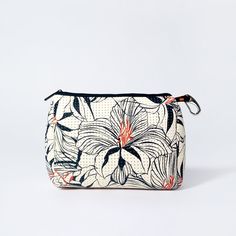 a white and black floral print pouch with zipper