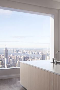 a kitchen with a view of the city from it's high rise window sill