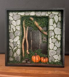 a wooden frame with some pumpkins in it