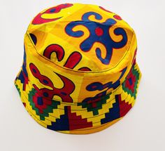 "--Description-- This unique hat has been beautifully handcrafted in Ghana (Kumasi). The hat is perfect for any occasionto show your vibrant and colourful style at a festival, party, holiday or just for your everyday go-t o accessory; just to name a few. It is also a great item for sun protection.  --Size/Circumference-- Approx. 24\" (61cm) --Colours-- Multicoloured --Material-- Cotton  --Washing instructions-- Hand wash with cold water only. * If you have any questions about this item, please c Ghana Kumasi, Kente Print, Colourful Style, African Black Soap, Unique Hats, Black Soap, Bucket Hats, Festival Party, Washing Instructions