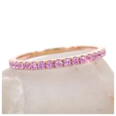 This feminine light pink sapphires eternity band is the perfect complement to any engagement ring or as stackable bands. •Based on ring size 6.5•Metal: 18K Rose Gold•Stones: Genuine Sapphires•Color: Light Pink •Stone Count: 44 PCS•Weight: 0.43cts T.W •Band Width: 1.5mm ( +/- 0.1mm in variation)----------------------------------------Carat weight & stone count varies depending on the ring size.----------------------------------------Beautiful Ring Box Included -------------------------------- Pink Sapphire Ring With Single Cut Diamonds, Pink Stackable Fine Jewelry, Pink Fine Jewelry Stackable, Stackable Pink Sapphire Jewelry In Pink, Pink Cubic Zirconia Stackable Jewelry, Pink Stackable Cubic Zirconia Jewelry, Pink Half Eternity Jewelry Gift, Pink Ring With Single Cut Diamonds In Round Cut, Fine Jewelry Pink Round Cut Eternity Band