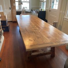 a large wooden table sitting in the middle of a living room