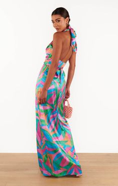 A knockout like the Adele Halter Maxi doesn't come around often! Drapey luxe satin sweeps across the front to create a halter wrap neck with a sultry backless moment. A detachable sash and side slit instantly elevate this maxi even further. Highlighted in this lively print, this maxi is the perfect companion for your next special event or jet-setting with you on your upcoming tropical vacay. Guava Punch, Halter Maxi Dress, Halter Maxi, Halter Maxi Dresses, Neck Wrap, Adele, Jet Set, Special Event, Special Events