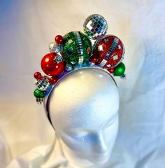 Add holiday spirit to your hairstyle with this fun, bright , tacky headband ! Handmade using festive holiday ornaments that sparkle and shine, set on a 1 inch wide, satin headband . Each unique headband is handcrafted with great care and  attention to detail . A perfect and fun  accessory for all of your holiday festivities!  Headband is 13 inches from end to end, over the head .   Headband contains small embellishments that can be a choking hazard to small children.  HANDLE EMBELLISHED HEADBAND Christmas Lights In Hair, Ornament Headband, Christmas Headdress, Christmas Headpiece, Disco Christmas, Tacky Christmas Party, Christmas Headbands, Unique Headband, Embellished Headband