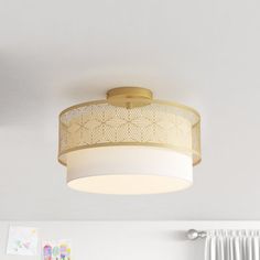 a ceiling light in a bedroom with white walls