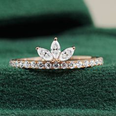 a close up of two wedding rings on top of a green cloth