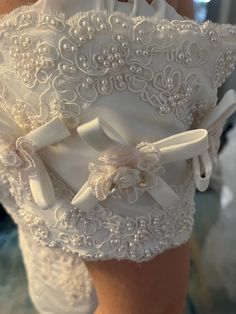 the back of a woman's white wedding garter