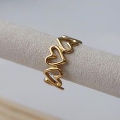 Embrace your inner girly-girl with our Heart Ring. This adjustable ring features a delicate open heart design that adds a touch of sweetness to any look. Perfect for adding a unique touch to your everyday style. (Girly-girl approved!) -stainless steel, gold plated Details • Made in United States • Weight: 0.07 oz (1.98 g) Cute Adjustable Midi Promise Rings, Delicate Adjustable Open Heart Ring, Metal Heart Ring As Gift, Heart Shaped Open Ring As Gift, Heart-shaped Open Ring As Gift, Open Heart Ring Metal Gift, Adjustable Metal Heart Ring For Valentine's Day, Heart-shaped Open Ring Metal Gift, Metal Open Heart Ring Gift