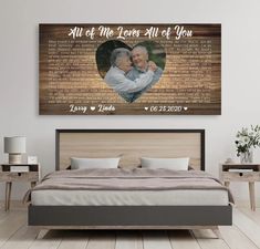 a bed with a wooden headboard and two pictures on the wall above it that says, all of me loves will be you