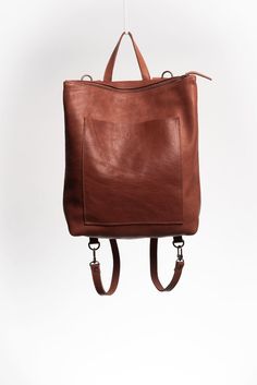 "The Andes is an unlined spacious convertible leather backpack. The generous exterior pocket allows you to keep your wallet and phone handy at all times. The leather straps can easily switch between positions, transforming the backpack into a satchel-tote, so you can use the bag in two different ways. Handcrafted by artisans in Argentina, and made with full-grain vegetable-tanned leather dyed with natural pigments respecting the environment. Height: 16\" Width at the top: 12\" Width at the bottom: 15\" Depth: 4.5\" Length of Straps: 28\" Fits a 15\" laptop, and much more!" Sustainable Backpack, Leather Designs, Handmade Backpacks, Leather Ideas, Natural Pigments, Satchel Backpack, Leather Duffle Bag, Leather Dye, Convertible Backpack