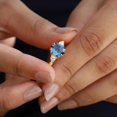 Hexagon is the new round! For those looking for an alternative ring to traditional shapes and cuts, let us introduce you to Rana - a hexagon-shaped London Blue Topaz Ring with a leaves band. Merging the modern cut with nature-inspired leaves, this is the perfect ring for a modern-day woman. Details: Center stone Center Octagon Topaz Ring With Accent Stones For Promise, Ring With Leaves, Alternative Ring, London Blue Topaz Ring, Blue Topaz Stone, Topaz Stone, Hexagon Shape, Blue Topaz Ring, London Blue Topaz