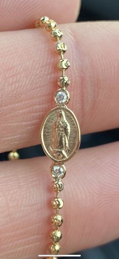 Genuine 14 karat gold diamond bracelet. Attached is a Virgin Mary with Two diamonds on either side. The bracelets contains roughly 0.10 cts of diamonds. The bracelet is available in 14k white, yellow, or rose. Bracelet comes in 6, 6.5, 7, 7.5, 8 & 8.5 in. Size 6 - Extra Small Size 6.5 - Small Size 7 - Medium Size 7.5 - Medium plus (men's medium Size 8 - Large Size 8.5 - Extra Large *Each of our beautiful diamond pieces are hand set by our expert diamond setter. Our goal is to provide quality Virgin Mary Bracelet Gold, Latina Jewelry Bracelet, Baddie Jewelry, Virgin Mary Bracelet, Diamond Evil Eye Bracelet, Latina Jewelry, Gold Diamond Bracelet, Diamond Evil Eye, Rose Bracelet