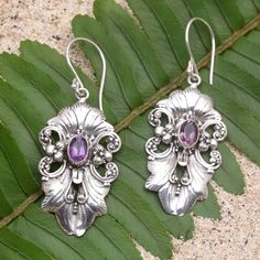 Designed especially for swanky events and upscale parties Giri Tasmana's dangle earrings are both elegant and elaborate. The Balinese artisan uses sterling silver to hand craft the floral motif centering each earring with a faceted amethyst stone for an unexpected pop of radiant color. Ornate Purple Dangle Earrings, Elegant Amethyst Chandelier Earrings For Gift, Handmade Elegant Amethyst Chandelier Earrings, Handmade Amethyst Chandelier Earrings, Elegant Amethyst Earrings For Party, Stylish Earrings, Hand Craft, Stylish Earring, Sterling Silver Dangle Earrings