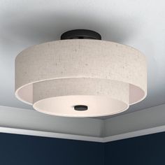 a ceiling light in a room with blue walls