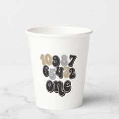 a white paper cup with numbers printed on it