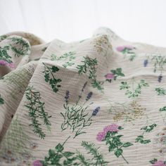 a blanket with flowers and leaves on it