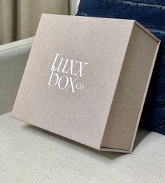 a box sitting on top of a couch